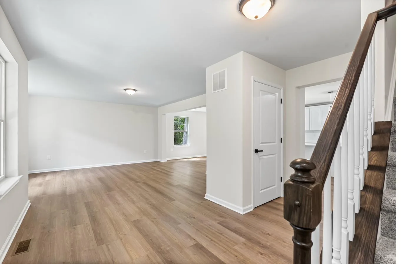 Lily model interior — entry foyer open to living room with staircase, new construction South Jersey