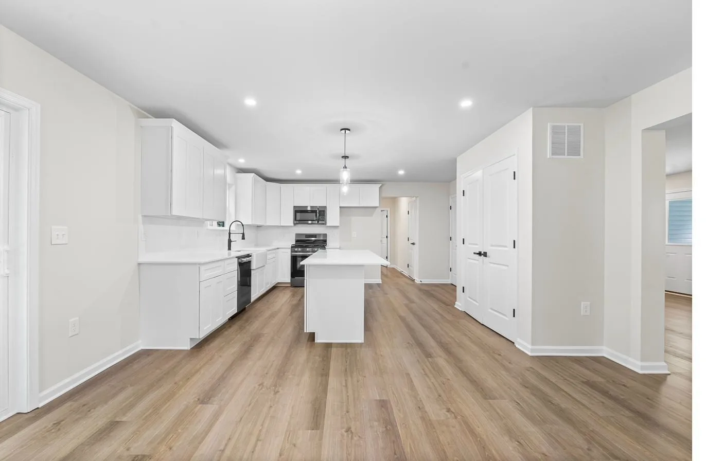 Lily model kitchen with center island and open concept living — new construction Newfield NJ