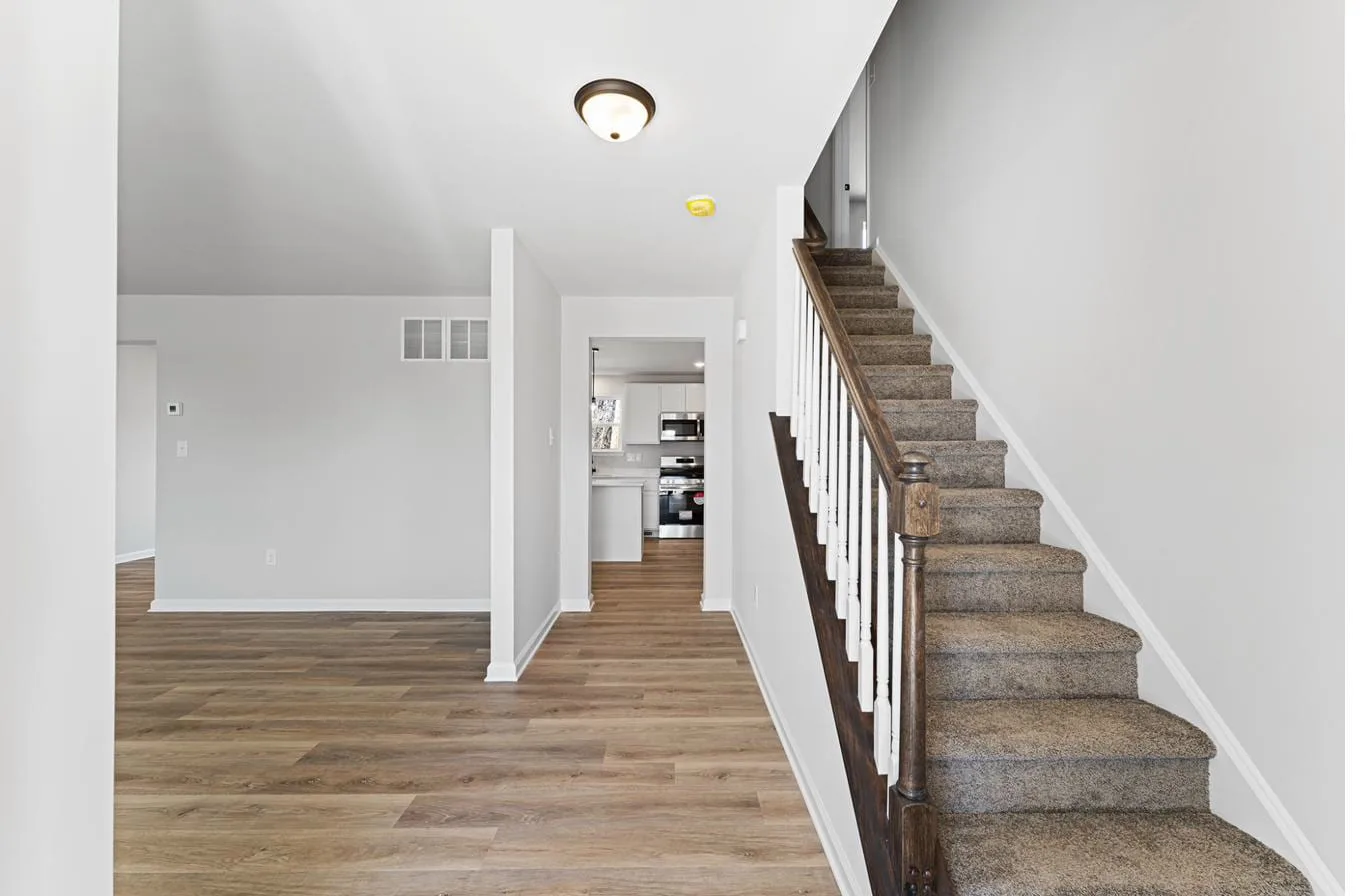 Isabella model 2-car garage interior — entry foyer with staircase, new construction South Jersey