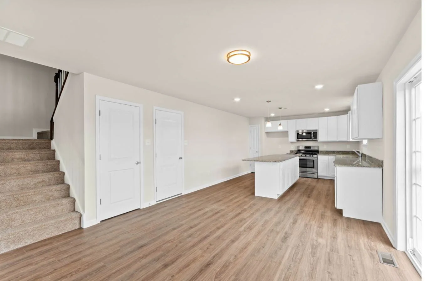 Cooper model living room and kitchen wide view — new construction South Jersey