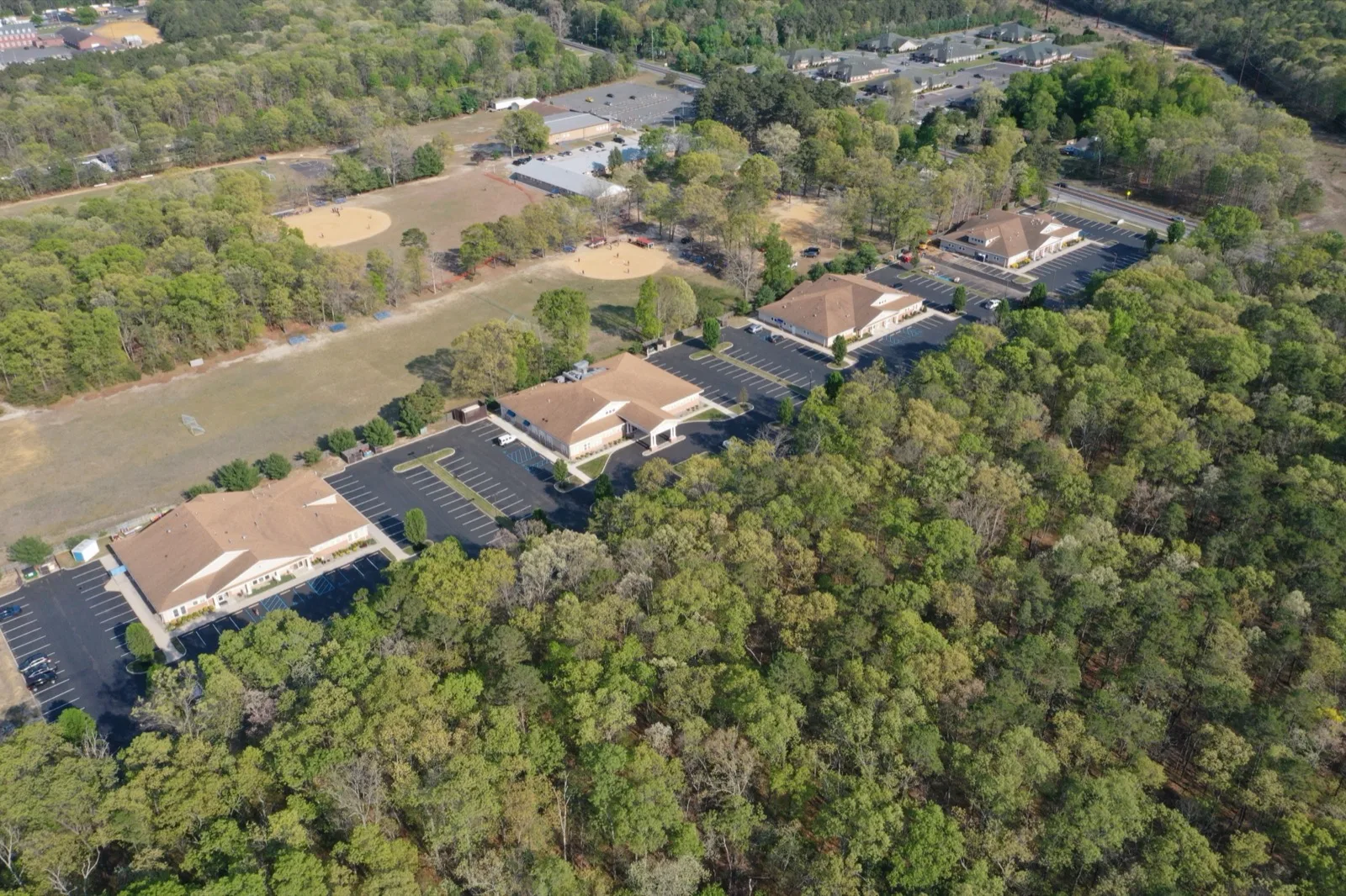 Aerial view over West Sherman Avenue in Vineland, with woods, open fields and low buildings