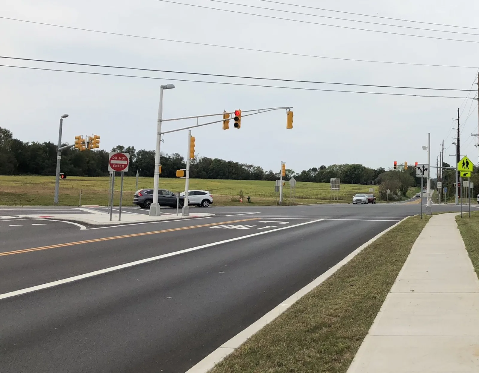 Kings Highway at Route 322 in Woolwich Township, with traffic signals and an open field beyond